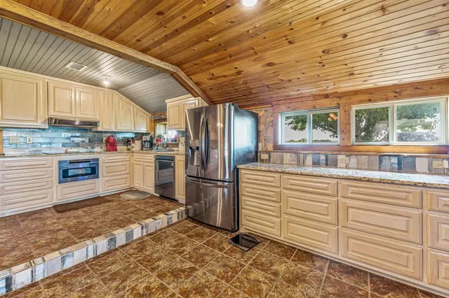 a kitchen with granite countertop a refrigerator and a stove