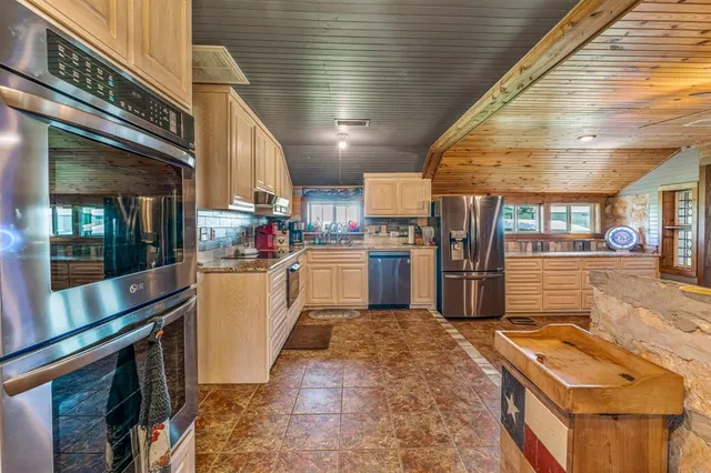 a kitchen with refrigerator and cabinets