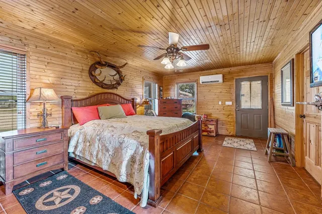 a spacious bedroom with a bed and a chandelier