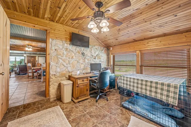a view of a livingroom with workspace and a window