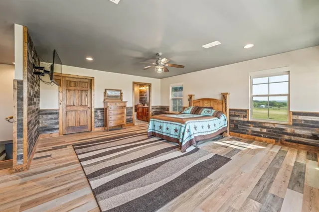 a spacious bedroom with a bed and a large window