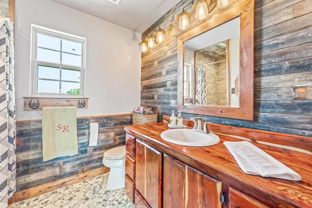 a bathroom with a sink a toilet and tub