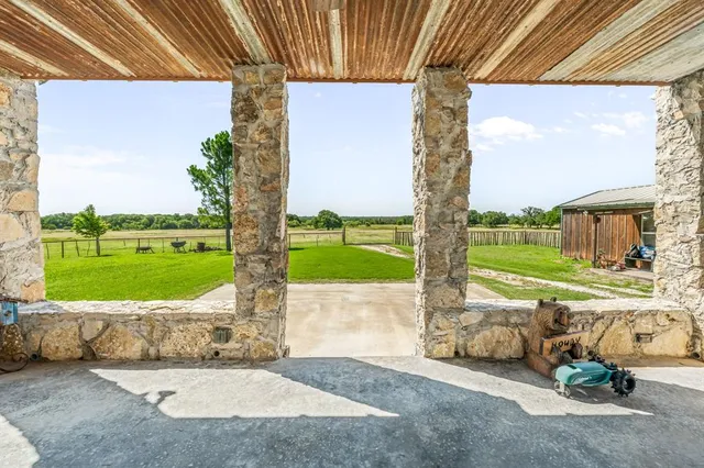 a view of a porch with furniture and garden