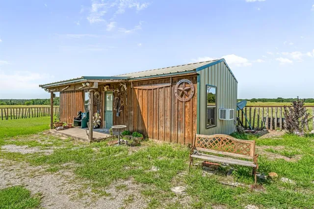 a view of a chair and table in backyard