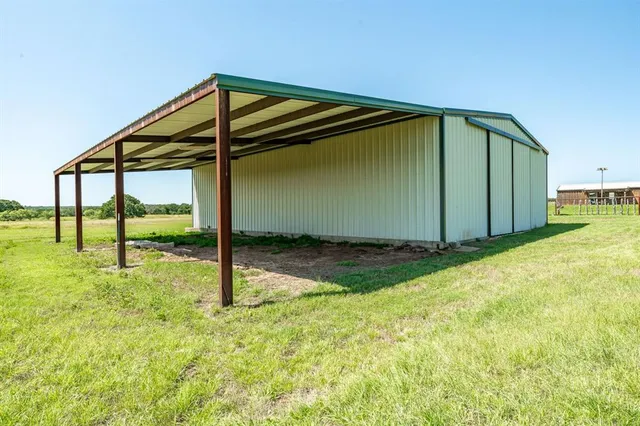 a backyard of a house with barbeque oven