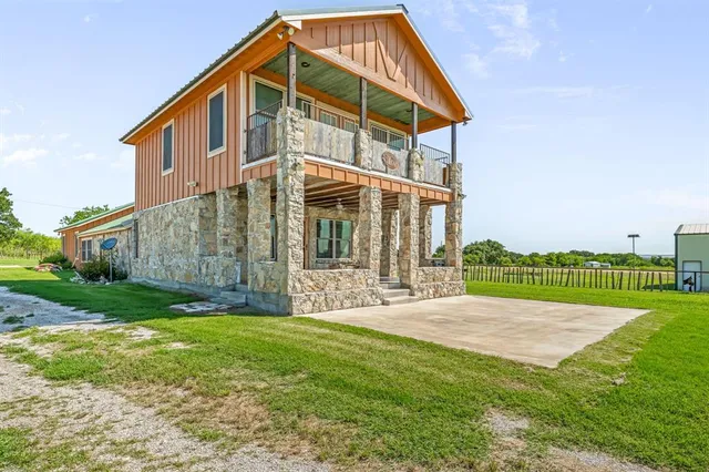 a view of a house with a yard and deck