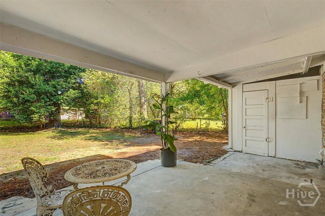12407 Deerfield Road Savannah, GA 31419 - Photo 26 of 34 Back patio and storage/workshop room
