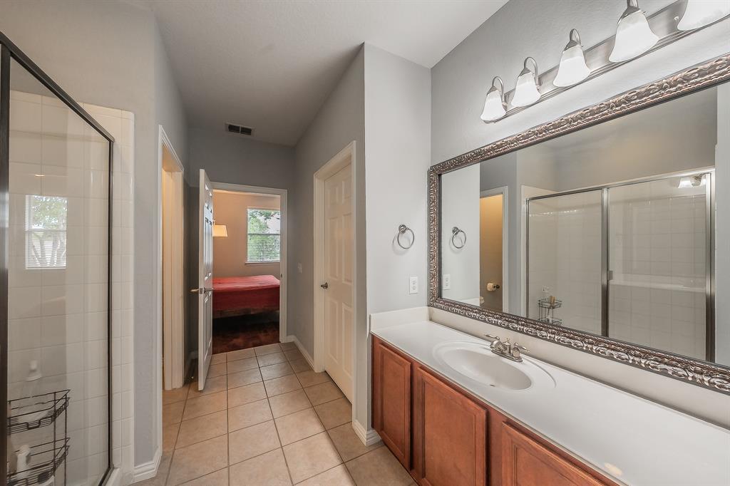 7253 Bianca Lane Plano, TX 75093 - Photo 10 of 18 a bathroom with a sink a mirror and a bathtub
