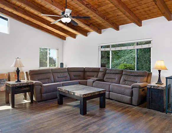 a bedroom with a bed and wooden floors