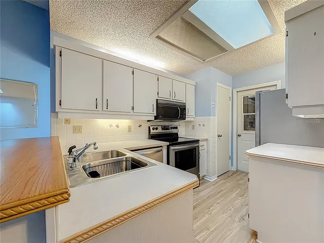 a kitchen with a sink a stove and refrigerator