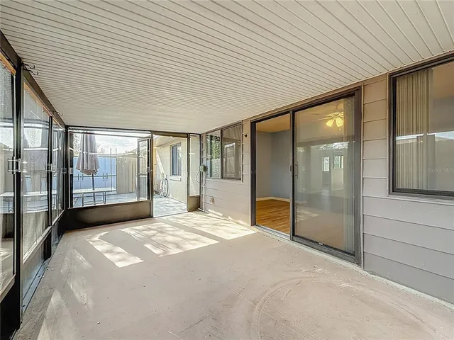 a spacious bedroom with a large window and a balcony