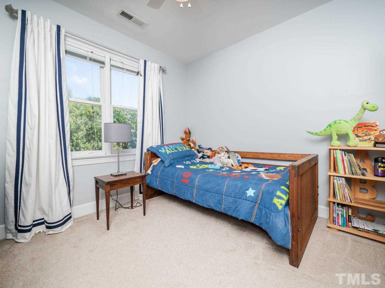 9101 Cub Trail Raleigh, NC 27615 - Photo 14 of 22 a bedroom with a bed and a book shelf