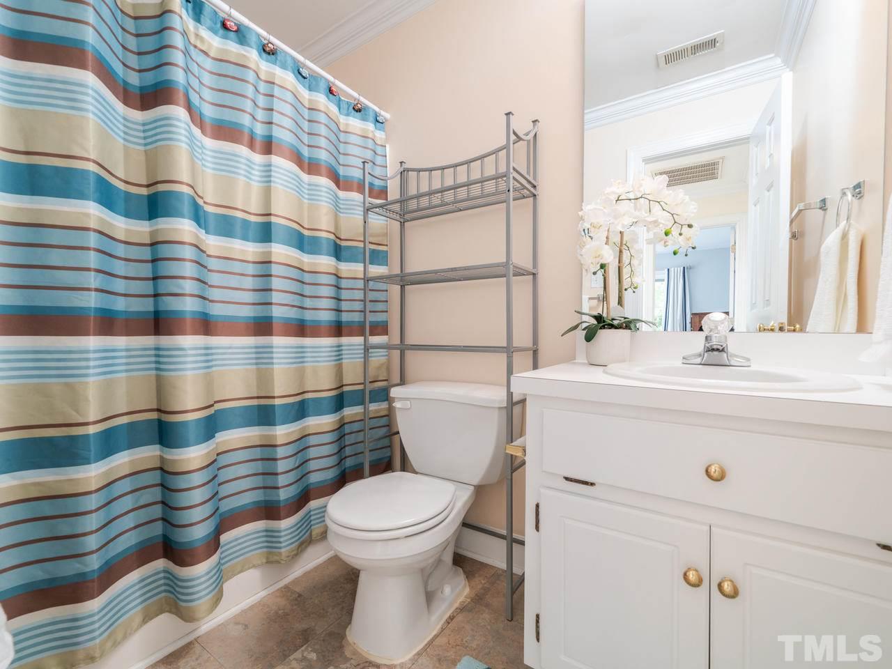 9101 Cub Trail Raleigh, NC 27615 - Photo 16 of 22 a bathroom with a sink a toilet and shower