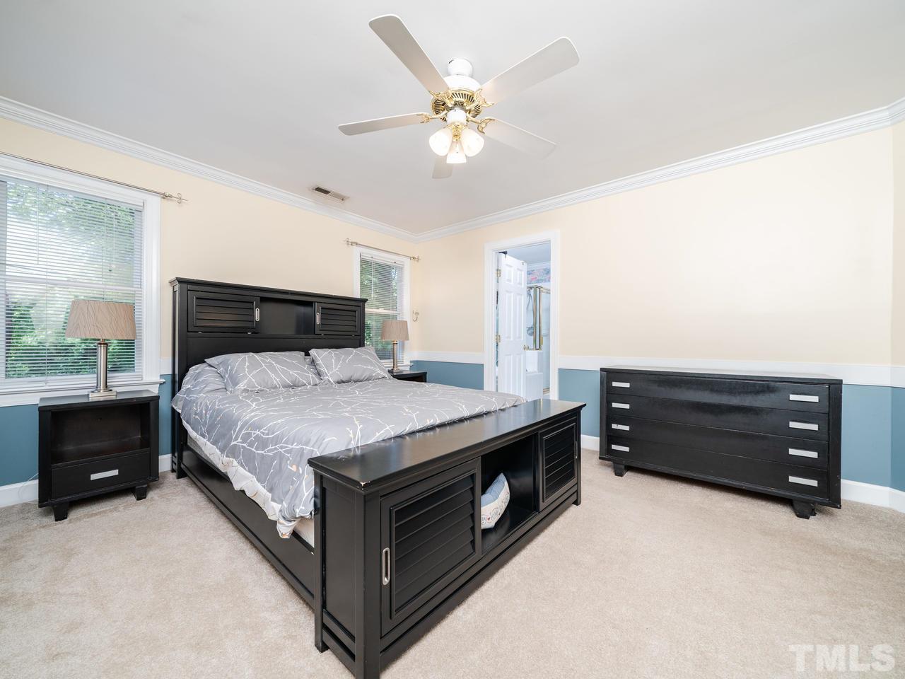 9101 Cub Trail Raleigh, NC 27615 - Photo 17 of 22 a bedroom with a bed and a ceiling fan
