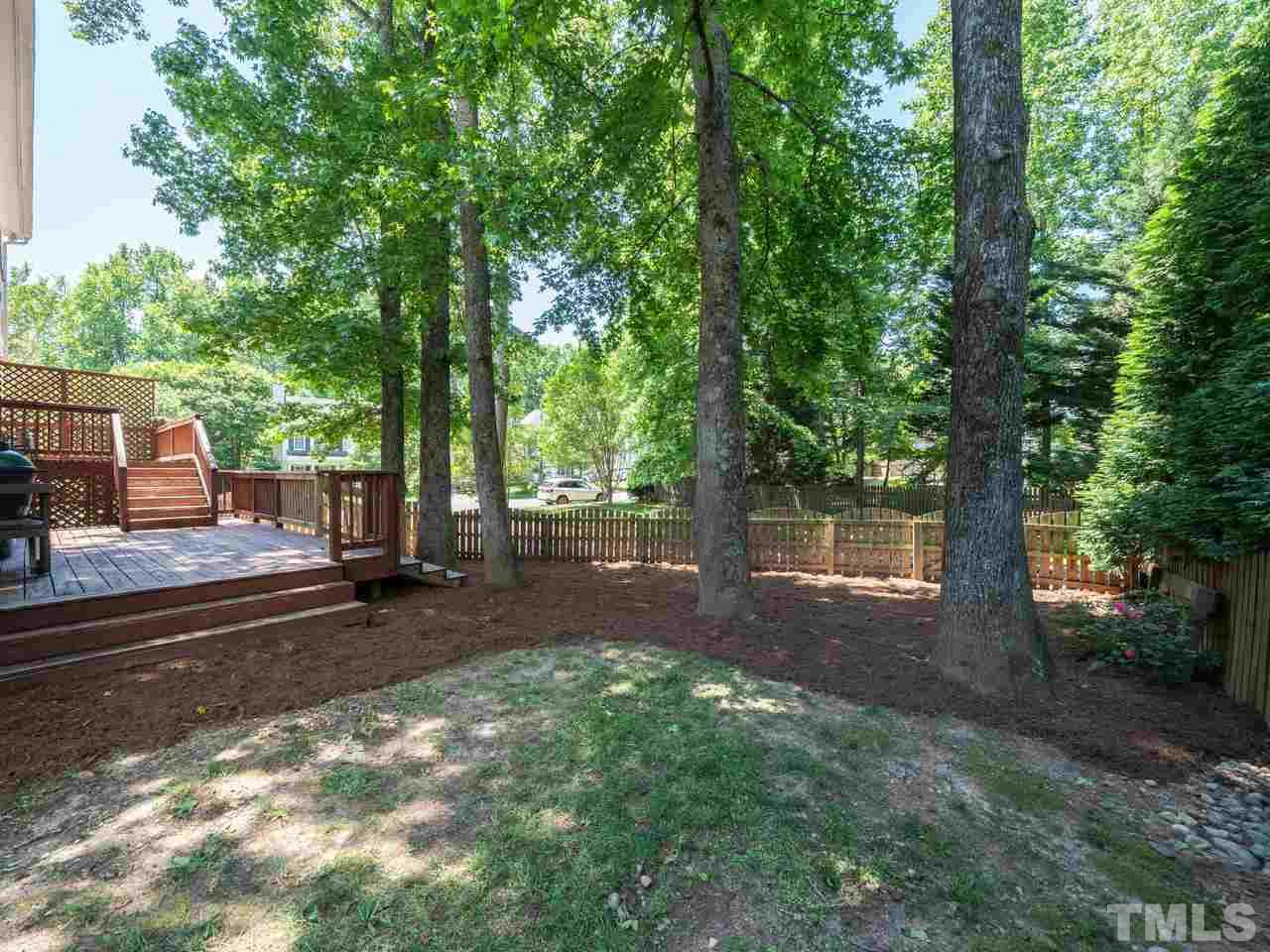 9101 Cub Trail Raleigh, NC 27615 - Photo 20 of 22 a view of a backyard with large trees and plants