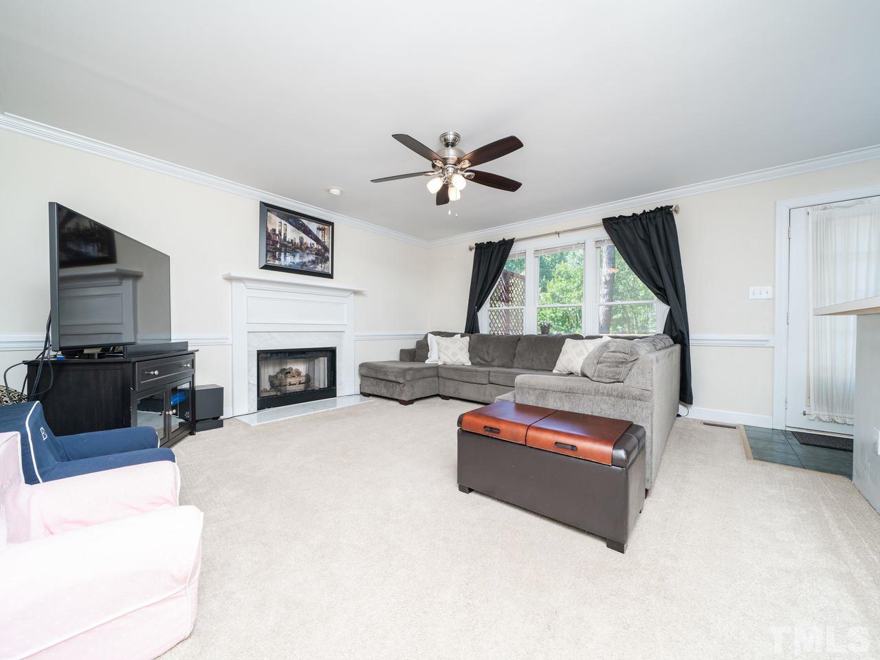 9101 Cub Trail Raleigh, NC 27615 - Photo 3 of 22 a living room with furniture fireplace and a flat screen tv