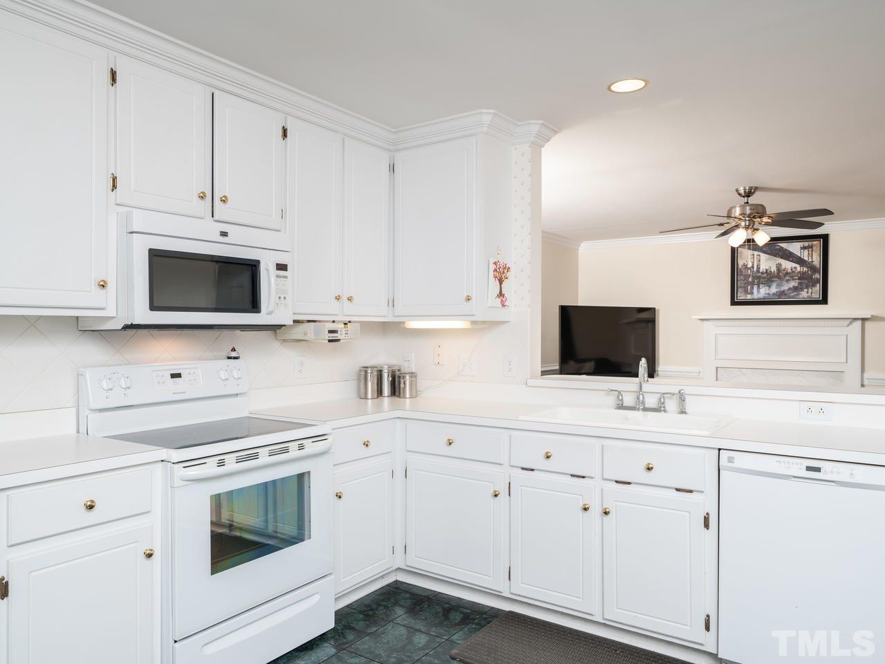9101 Cub Trail Raleigh, NC 27615 - Photo 7 of 22 a kitchen with appliances a sink and cabinets