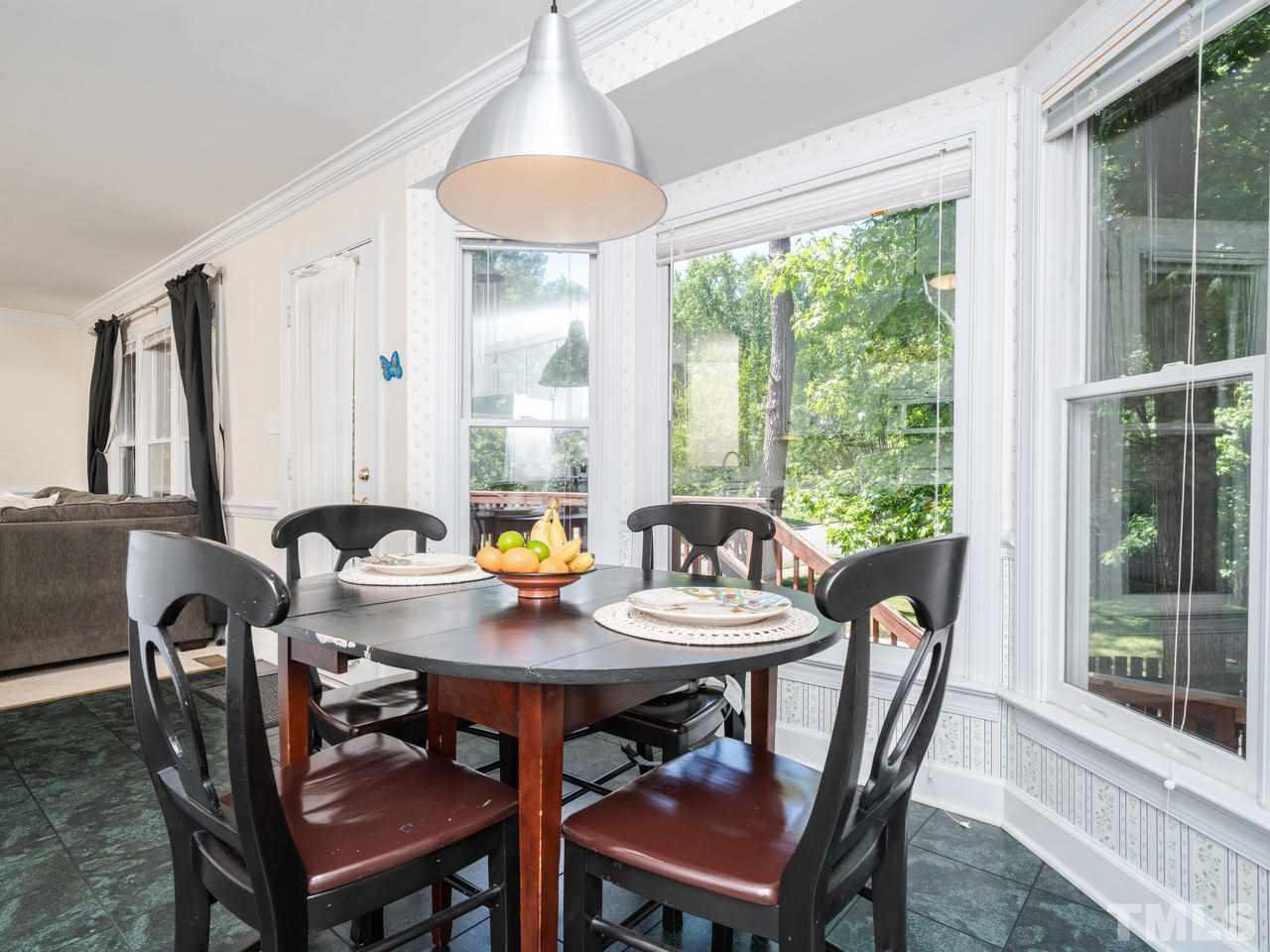 9101 Cub Trail Raleigh, NC 27615 - Photo 10 of 22 a view of a dining room with furniture window and outside view
