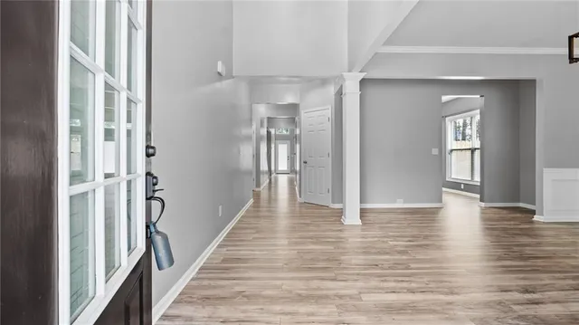 a view of a hallway with wooden floor