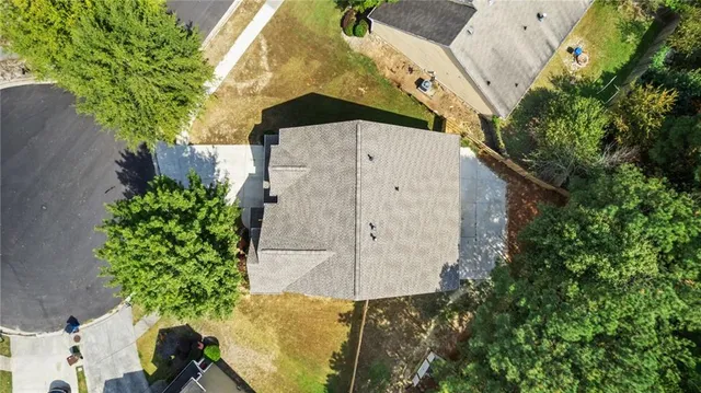 an aerial view of a house with a yard
