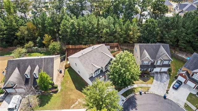 an aerial view of a house with garden space and street view