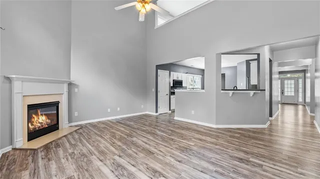 a view of a livingroom with wooden floor and a fireplace
