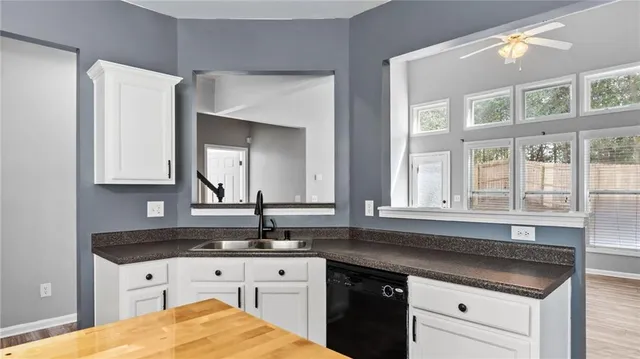 a kitchen with granite countertop a sink and cabinets