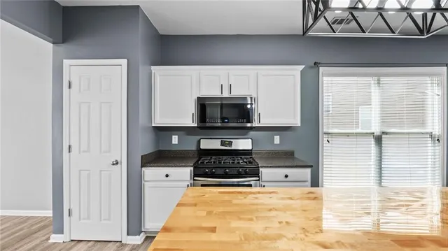 a kitchen with a stove and a white refrigerator