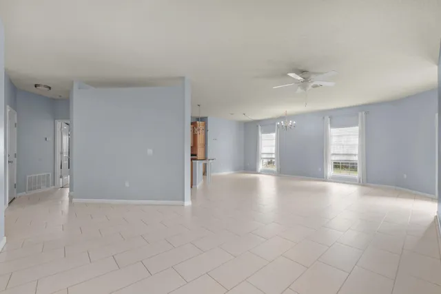 a bathroom with a granite countertop double vanity sink and a mirror