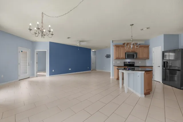 a kitchen with granite countertop a stove top oven microwave and cabinets