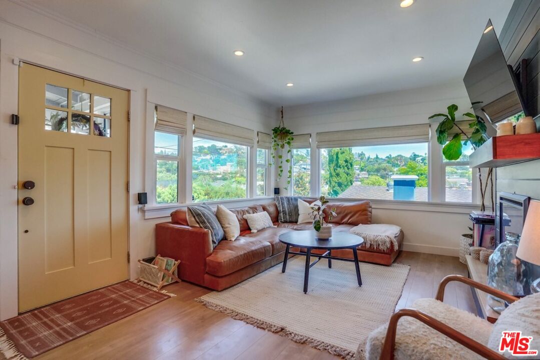 6116 Springvale Drive Los Angeles, CA 90042 - Photo 1 of 33 a living room with furniture a large window and a flat screen tv