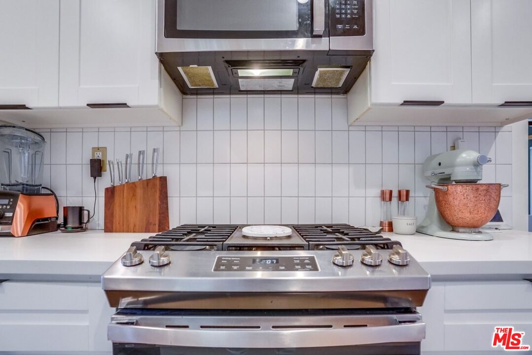 6116 Springvale Drive Los Angeles, CA 90042 - Photo 11 of 33 a stove sitting inside of a kitchen with cabinets