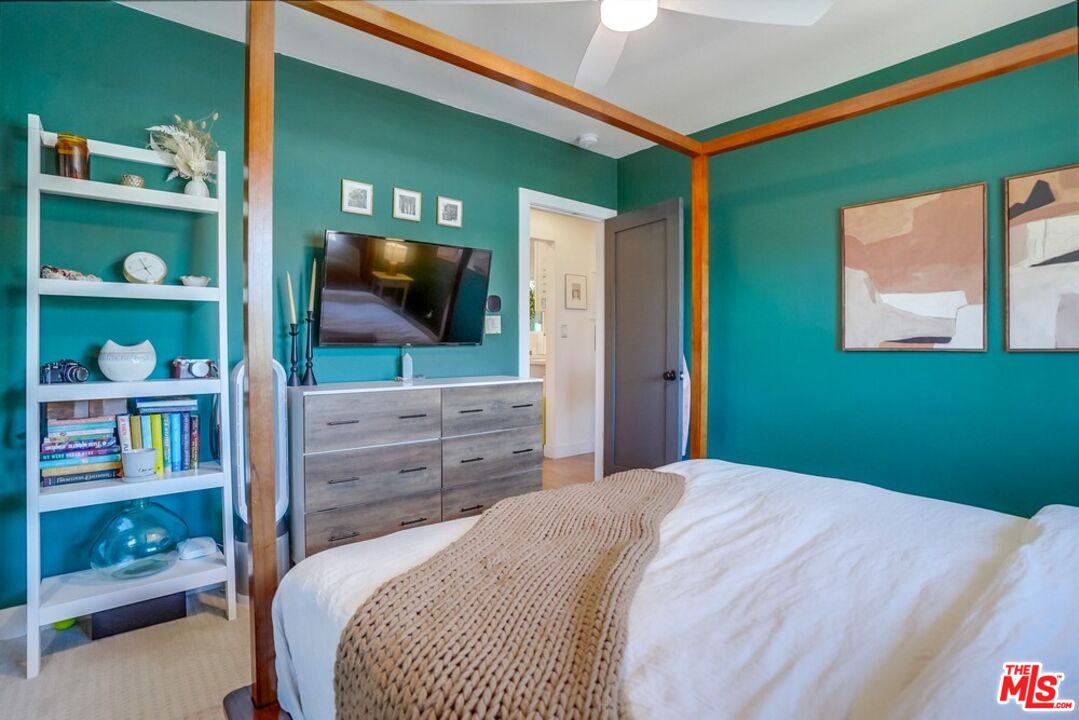 6116 Springvale Drive Los Angeles, CA 90042 - Photo 15 of 33 a bedroom with a bed and a flat screen tv