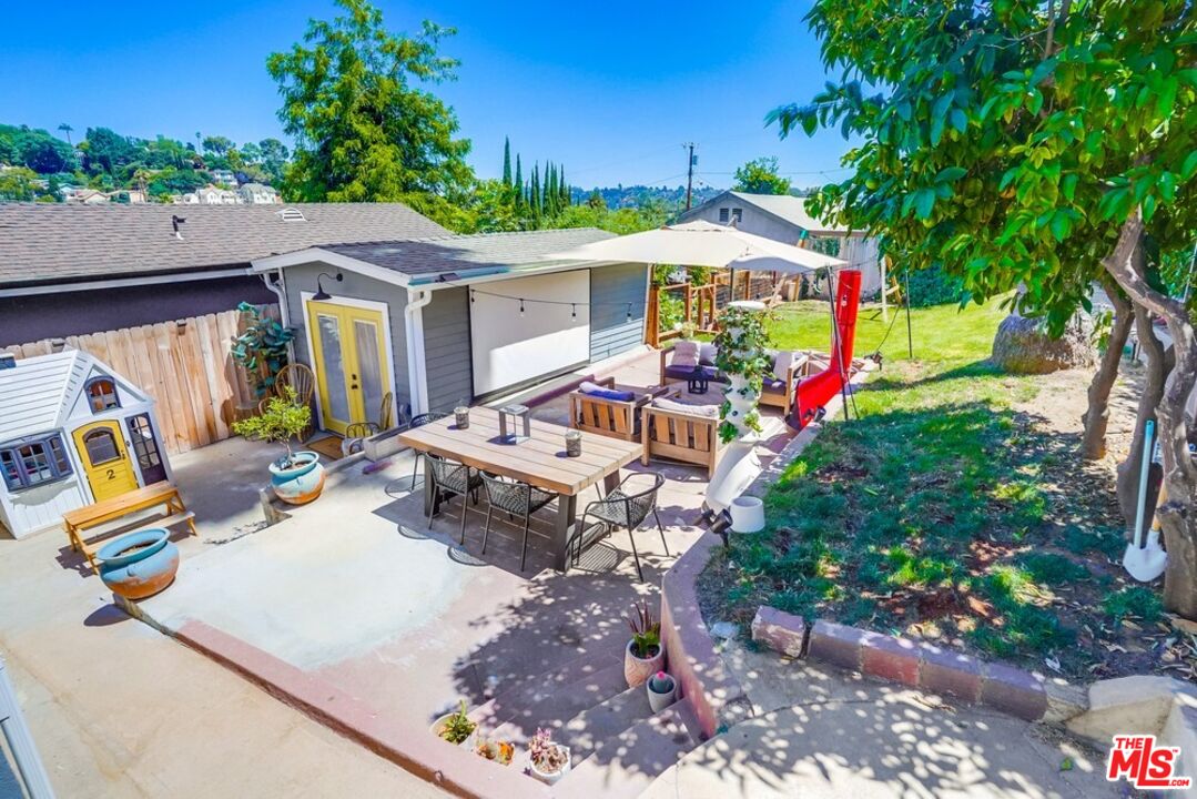 6116 Springvale Drive Los Angeles, CA 90042 - Photo 24 of 33 a view of a patio with table and chairs potted plants