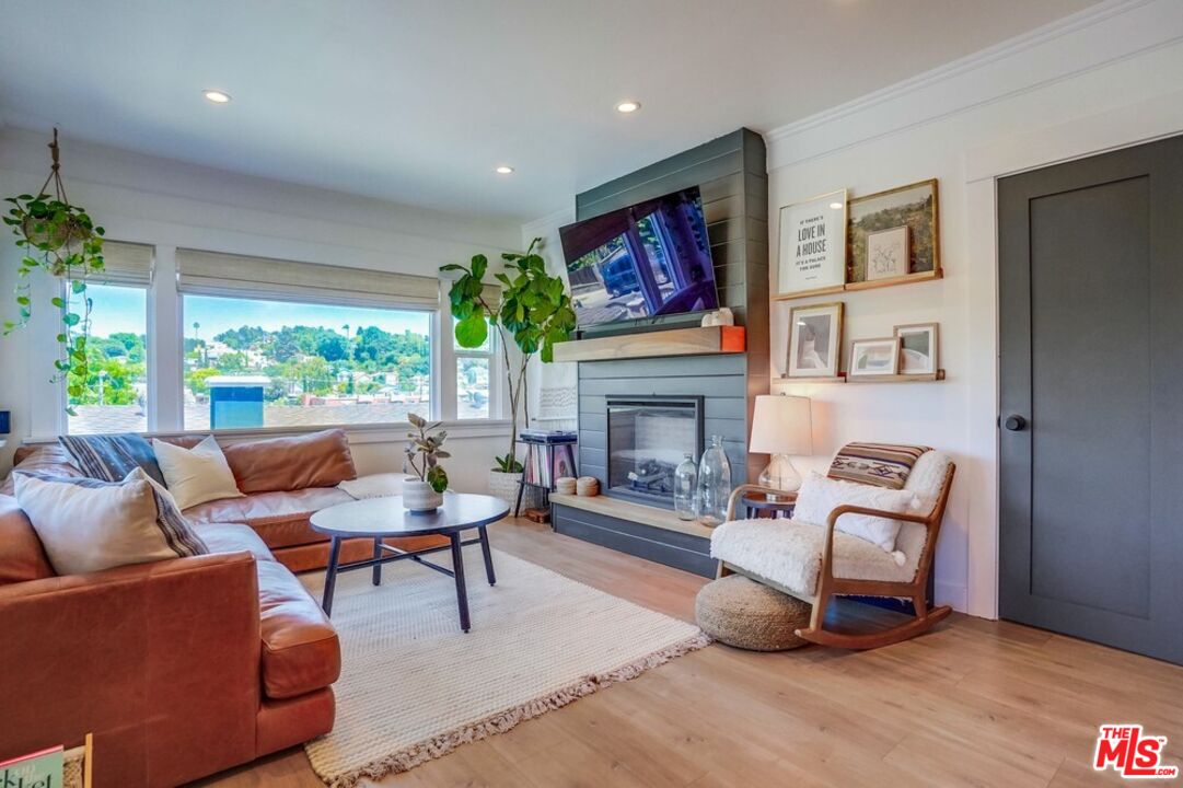6116 Springvale Drive Los Angeles, CA 90042 - Photo 5 of 33 a living room with furniture and a fireplace