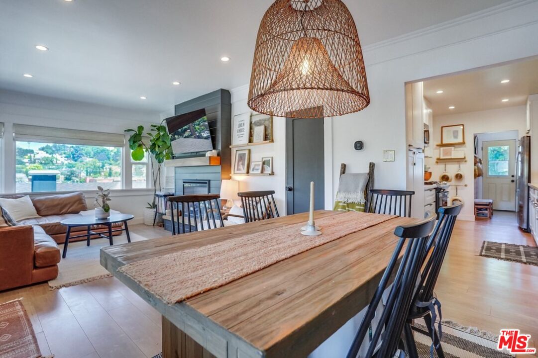 6116 Springvale Drive Los Angeles, CA 90042 - Photo 8 of 33 a dining room with furniture a chandelier and wooden floor