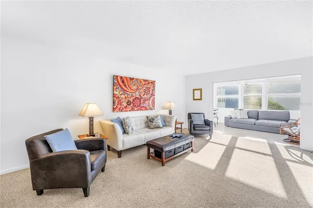 a living room with furniture and a potted plant on table