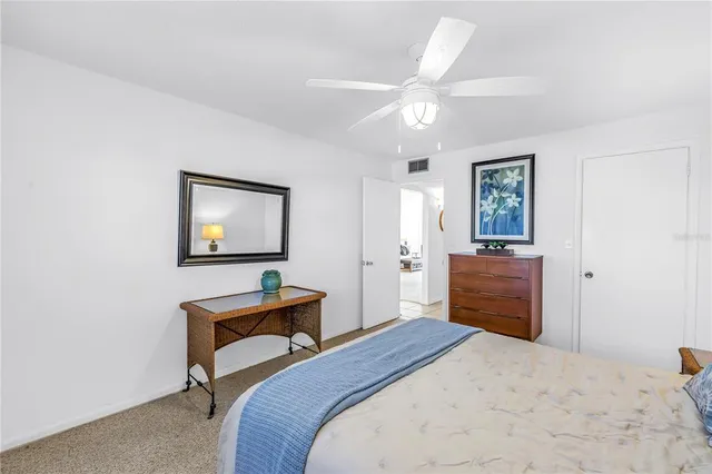 a bedroom with a bed and a dresser in it