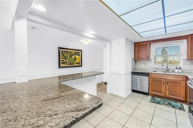 a kitchen with stainless steel appliances granite countertop a sink stove and cabinets