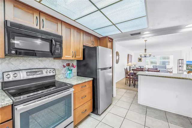 a kitchen with cabinets and steel stainless steel appliances