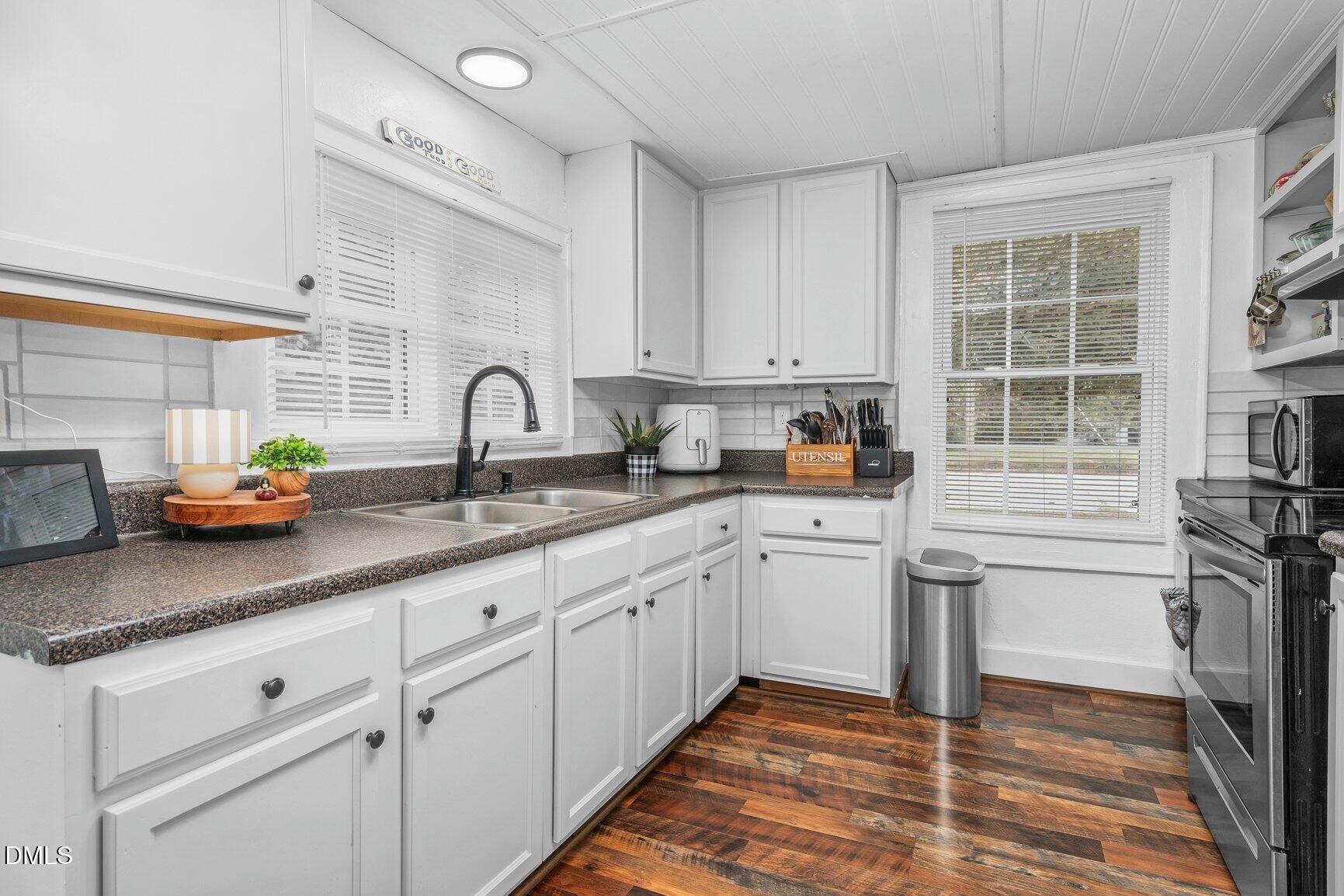 111 South May Street Spring Hope, NC 27882 - Photo 14 of 25 a kitchen with granite countertop a sink stainless steel appliances and cabinets
