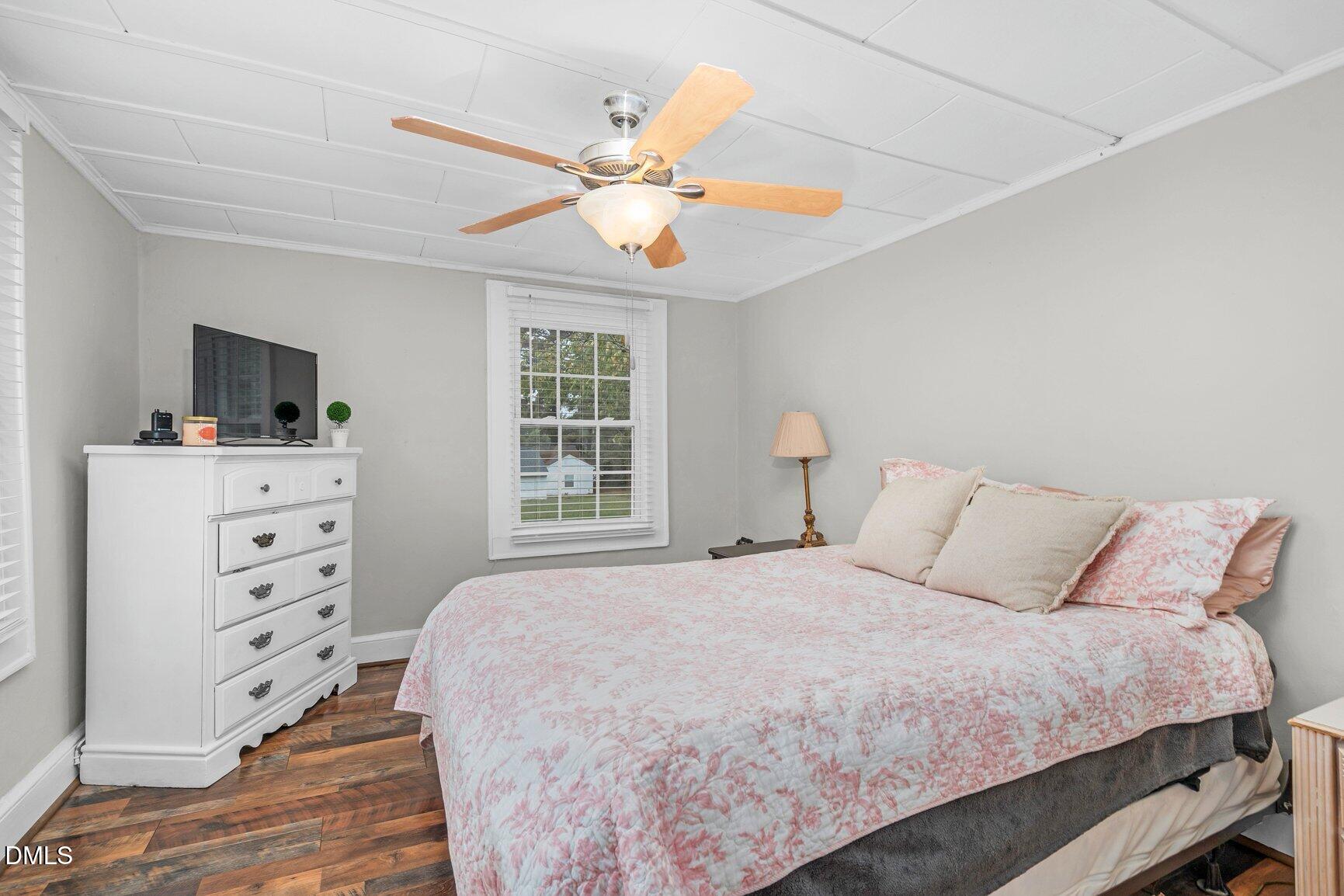 111 South May Street Spring Hope, NC 27882 - Photo 4 of 25 a bedroom with a bed and a flat tv screen on dresser