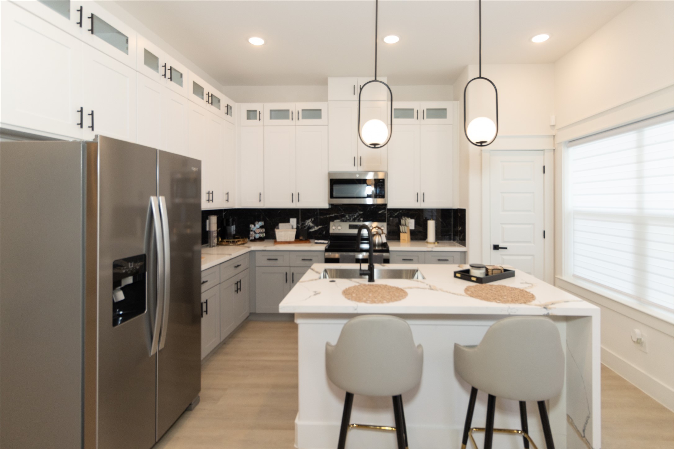 4902 Higgins Street, Unit B Houston, TX 77033 - Photo 12 of 39 a kitchen with stainless steel appliances granite countertop a sink a stove a refrigerator cabinets and chairs
