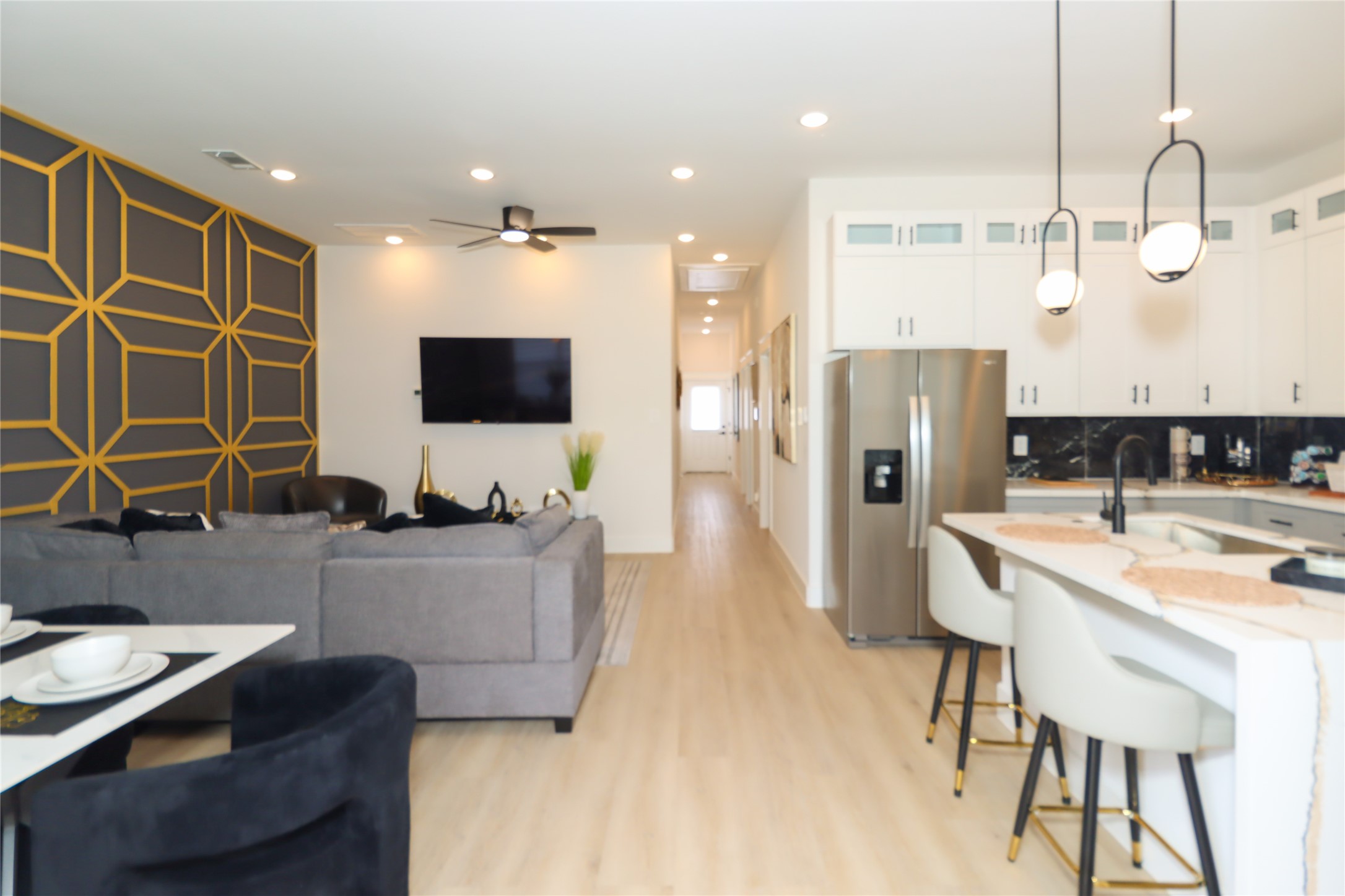 4902 Higgins Street, Unit B Houston, TX 77033 - Photo 13 of 39 a living room with stainless steel appliances kitchen island granite countertop a table chairs and a refrigerator