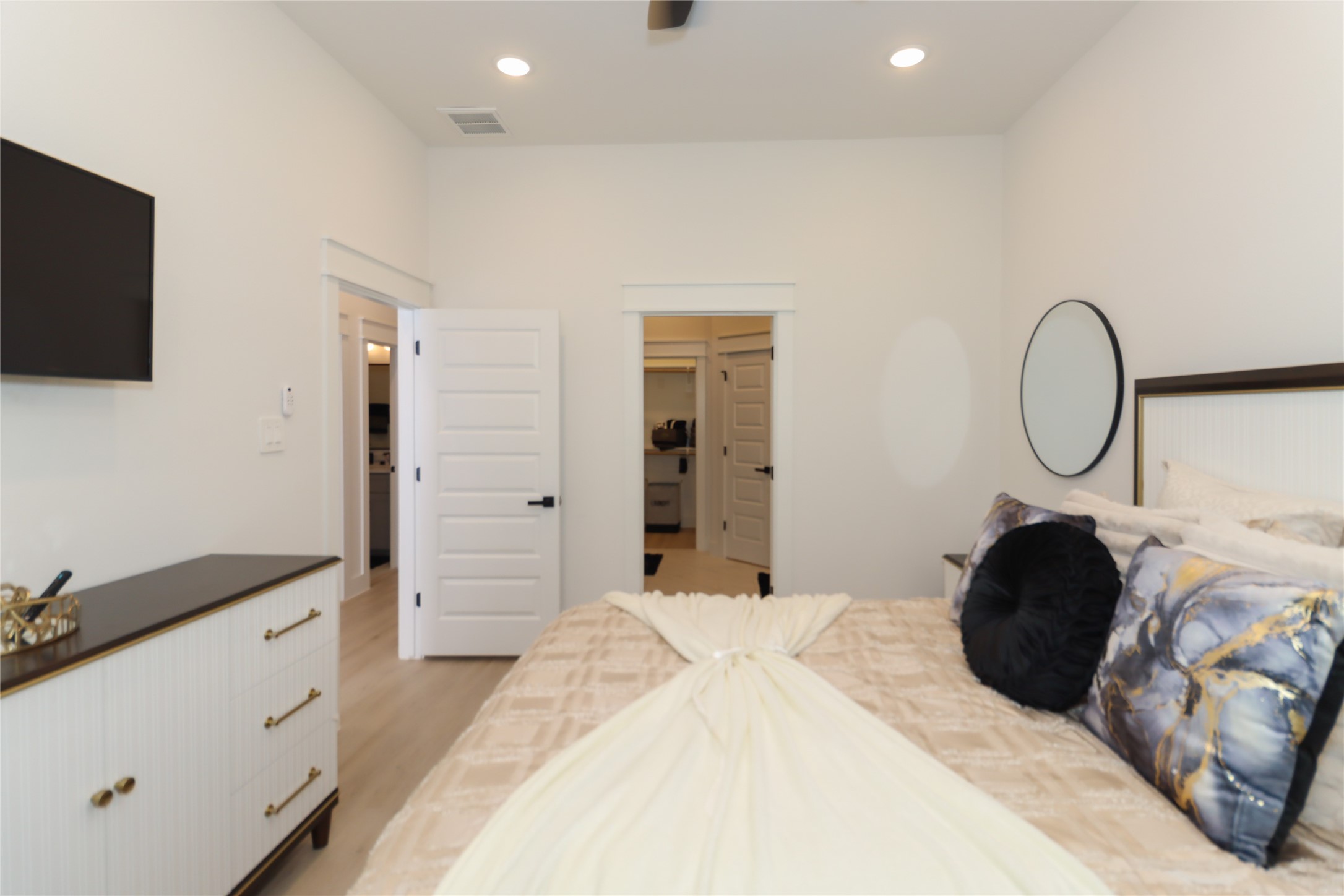 4902 Higgins Street, Unit B Houston, TX 77033 - Photo 16 of 39 a bedroom with a bed a flat tv screen and dresser