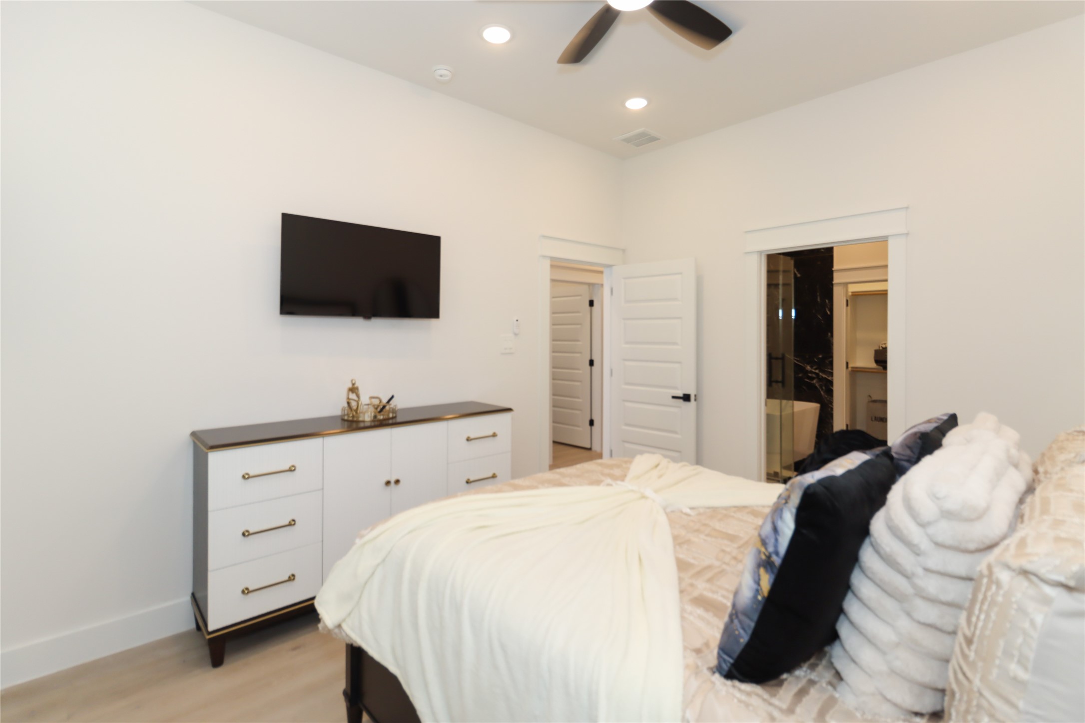 4902 Higgins Street, Unit B Houston, TX 77033 - Photo 20 of 39 a bedroom with a large bed and a flat screen tv