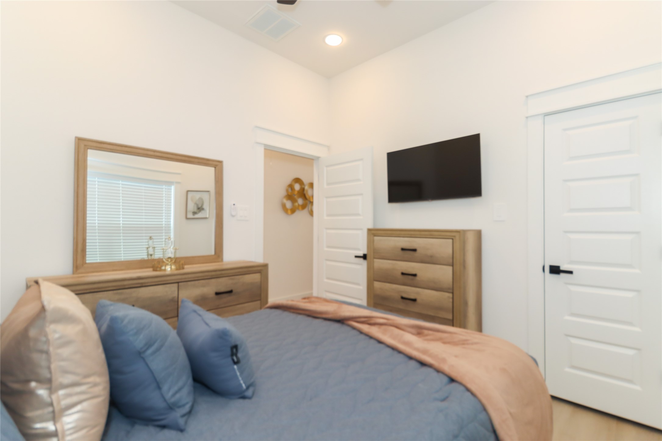 4902 Higgins Street, Unit B Houston, TX 77033 - Photo 26 of 39 a bedroom with a bed and a flat screen tv
