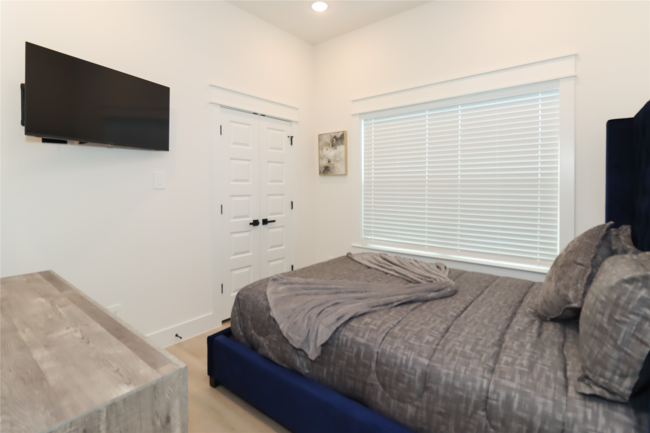 4902 Higgins Street, Unit B Houston, TX 77033 - Photo 31 of 39 a bedroom with a bed and a flat screen tv