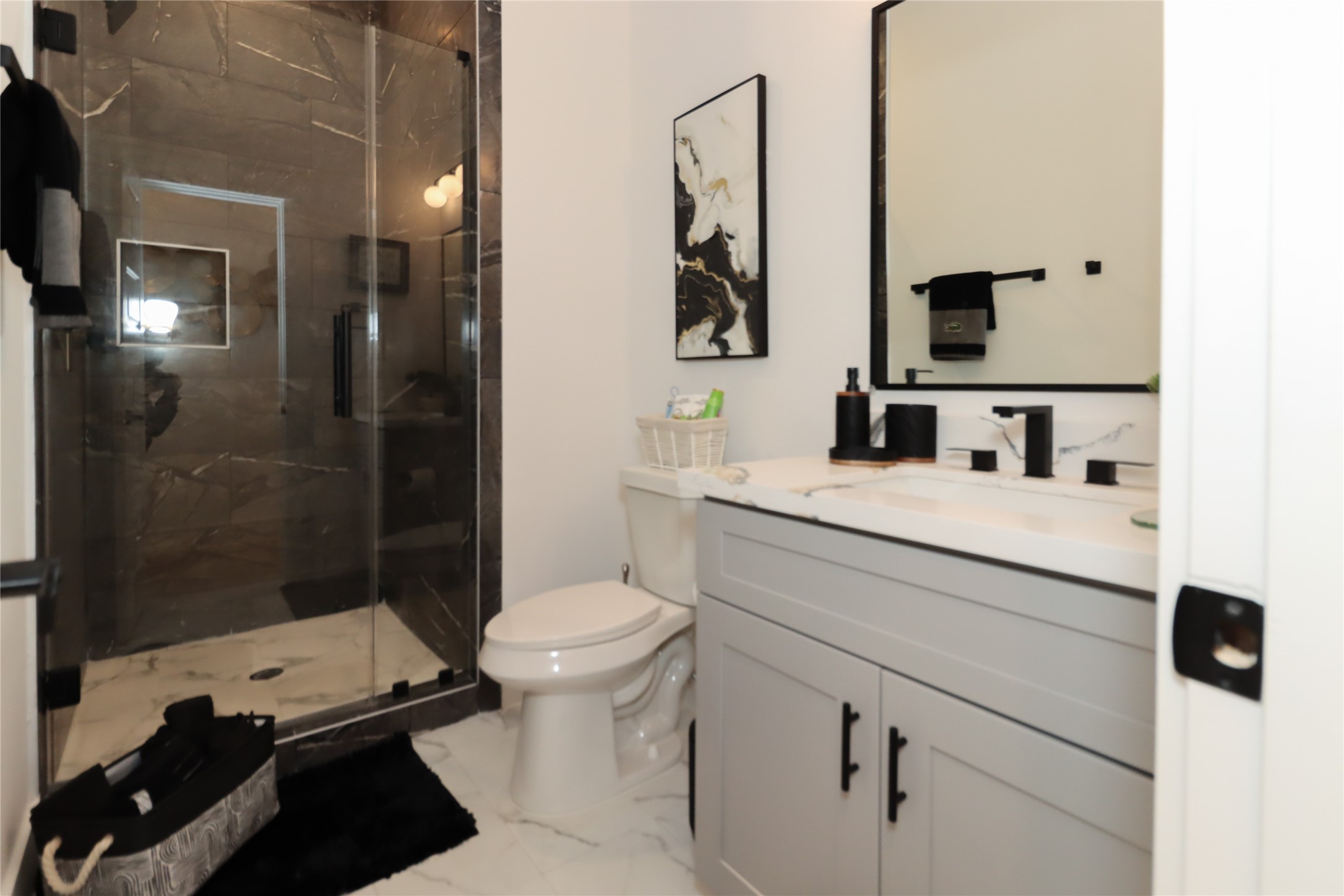 4902 Higgins Street, Unit B Houston, TX 77033 - Photo 32 of 39 a bathroom with a sink toilet vanity and shower