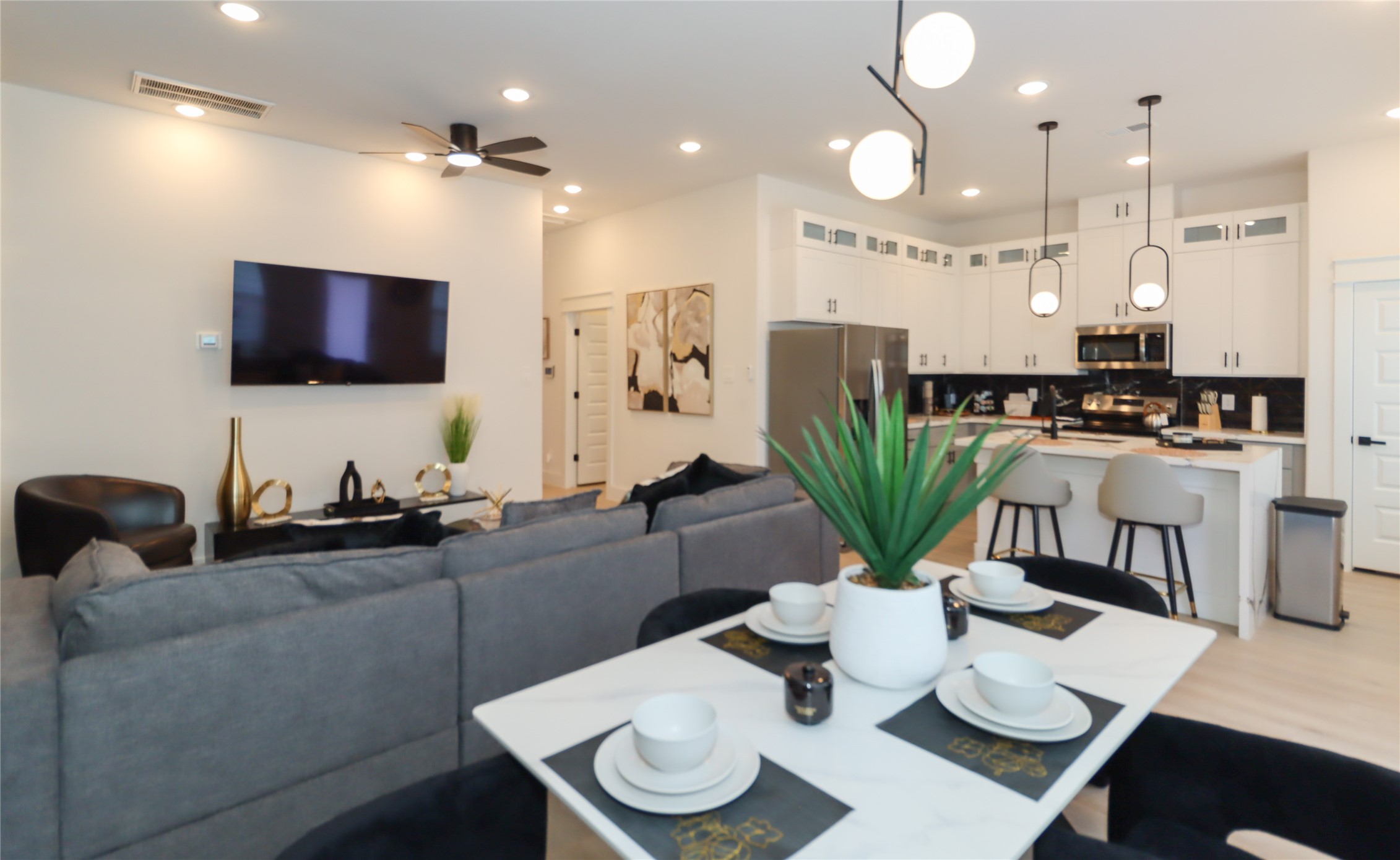 4902 Higgins Street, Unit B Houston, TX 77033 - Photo 8 of 39 a living room with furniture kitchen view and a flat screen tv